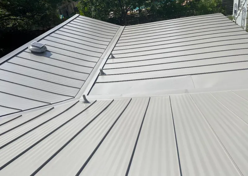 Solar attic fan installed on a metal roof for Roof Ventilation in Charlottesville